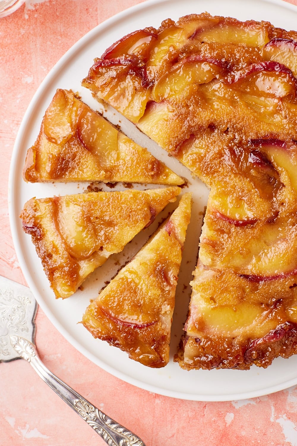Top-down view of a Peach Upside Down Cake with golden caramelized peach slices.