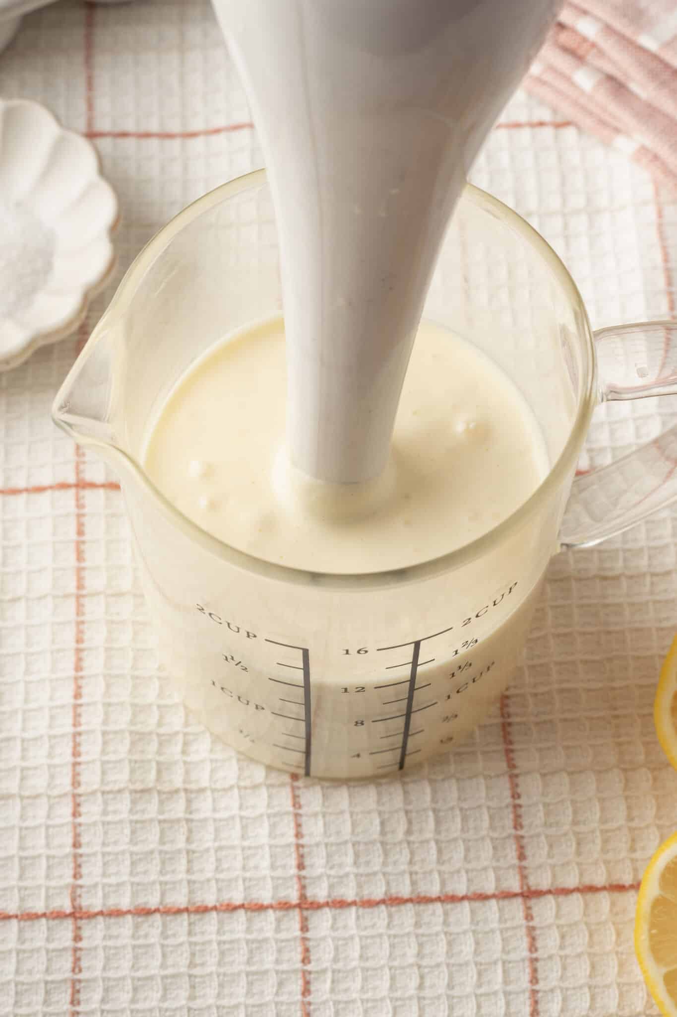 Blend homemade mayonnaise ingredients with an immersion blender in a jug.