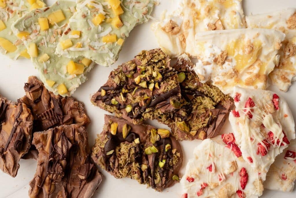Top down view of five flavors of frozen yogurt bark.