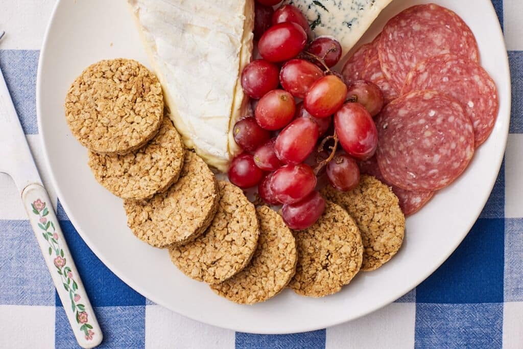Top-down view of Scottish Oat Cakes served with cheese and grapes.