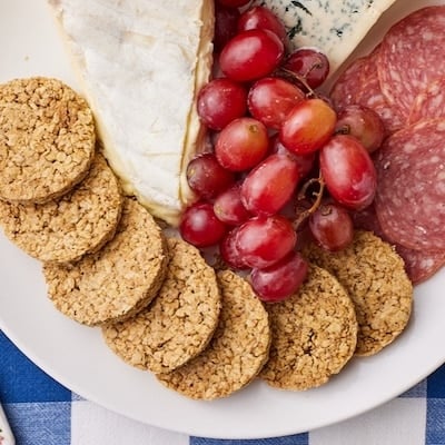 Top-down view of Scottish Oat Cakes served with cheese and grapes.