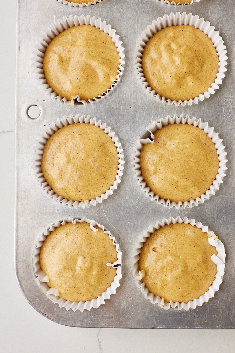 Apple Cider Muffins5 Divide the batter evenly among the prepared muffin tin.