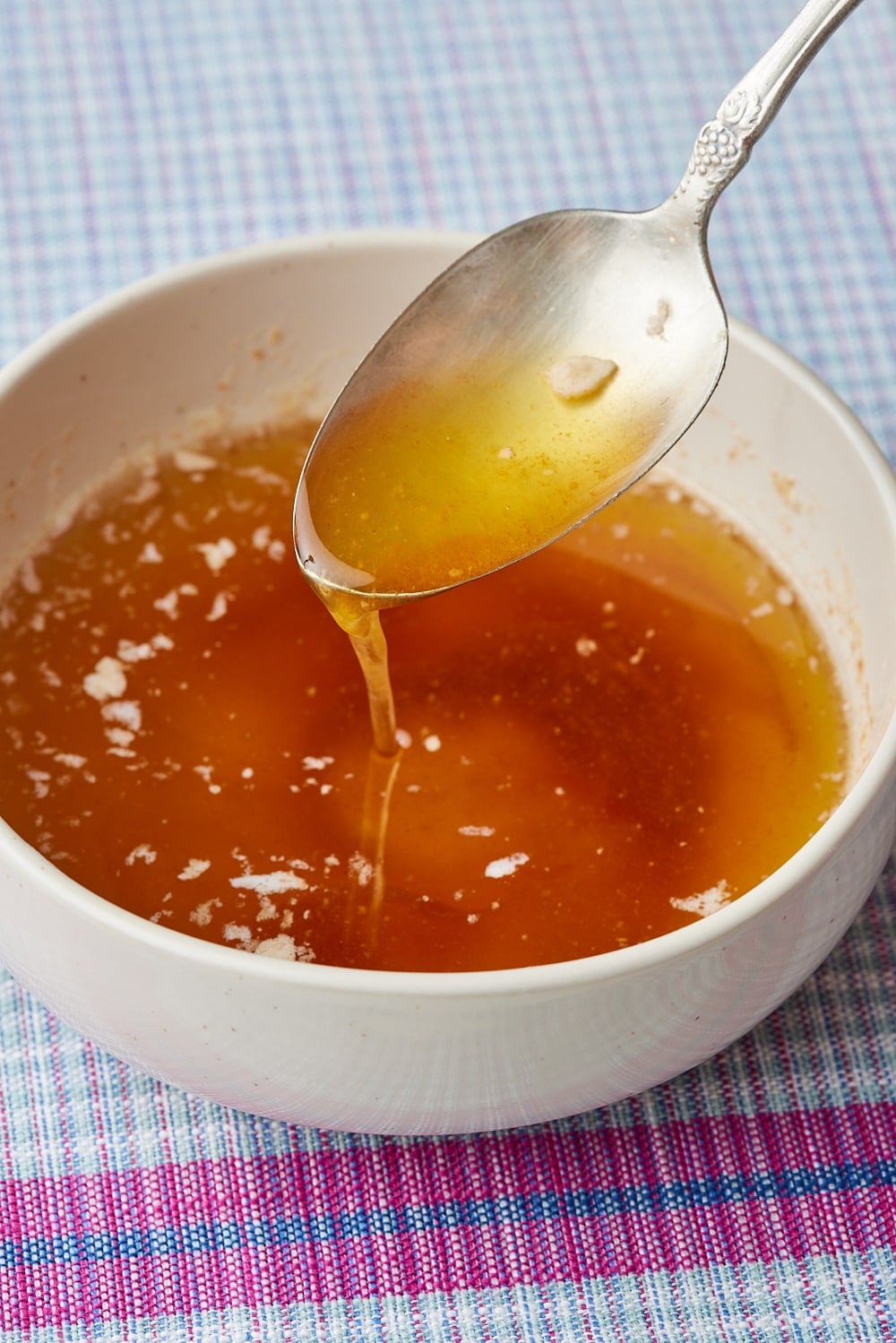 How to Make Brown Butter5 Golden brown butter drizzling from a spoon into a bowl.