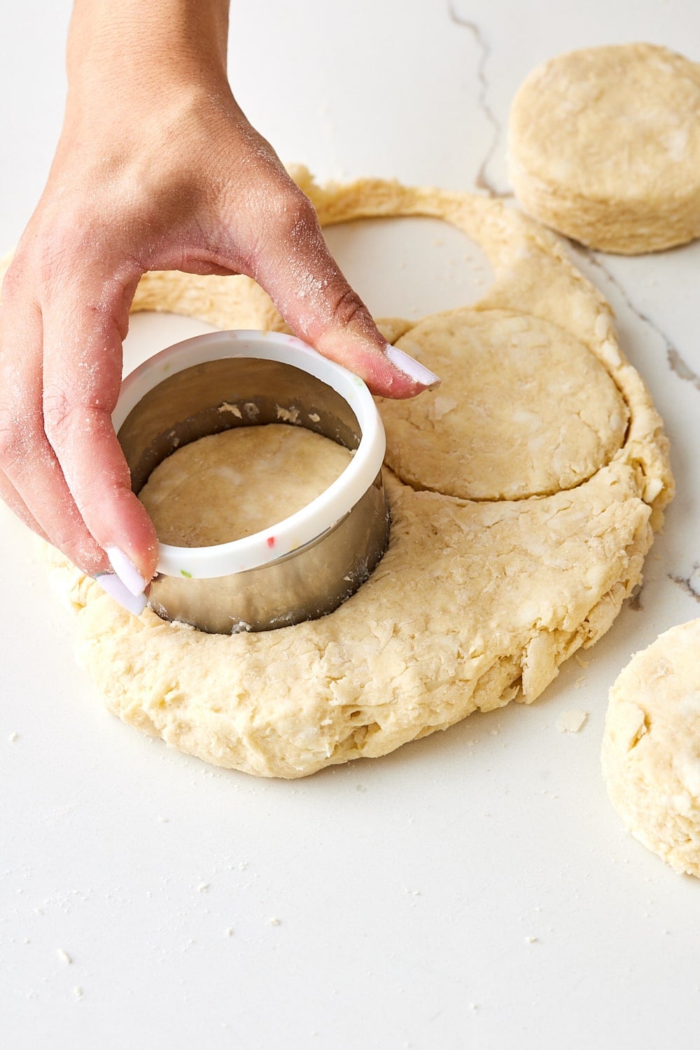Air Fryer Scones4 Cutting air fryer scones using a round cookie cutter.