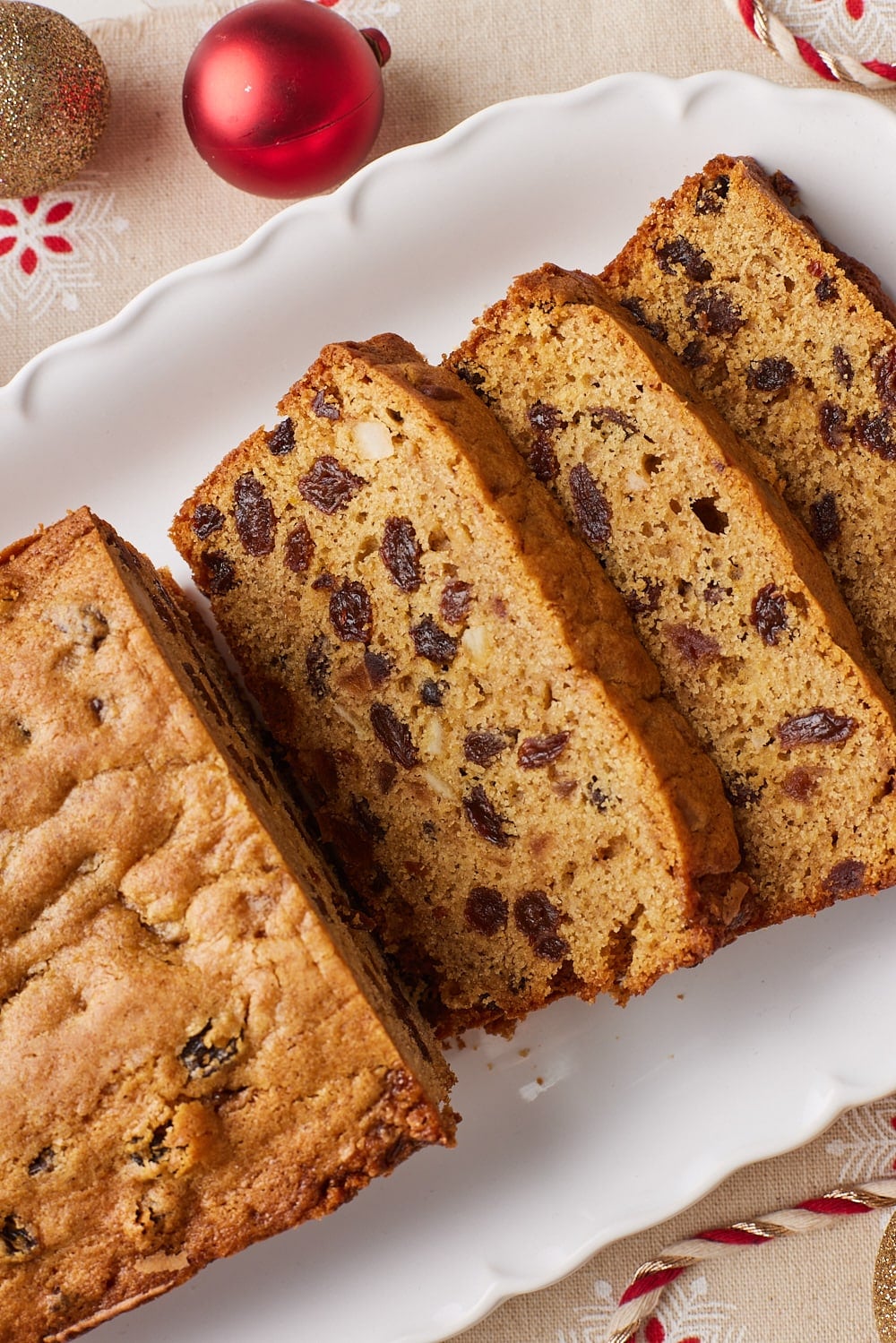  follow previous guide Skip the months of aging and bake a moist, fruit-packed Christmas loaf with warm spices and rich Irish whiskey flavor. This might also interest you. Ad User attachment alt Sliced moist fruitcake loaf with raisins on a white platter, styled with Irish whiskey bottles, red and gold Christmas ornaments, and festive red-and-white twine. User attachment Overhead view of raisins and candied citrus peel soaking in liquid in a clear glass bowl with a metal spoon, ready for making fruitcake. Ad User attachment Golden-brown fruitcake loaf baked with raisins in a parchment-lined loaf pan, shown from above on a white marble countertop. Ad User attachment Close-up of sliced moist fruitcake loaf showing a tender crumb studded with raisins, arranged on a white platter with red and gold Christmas ornaments and festive ribbon.