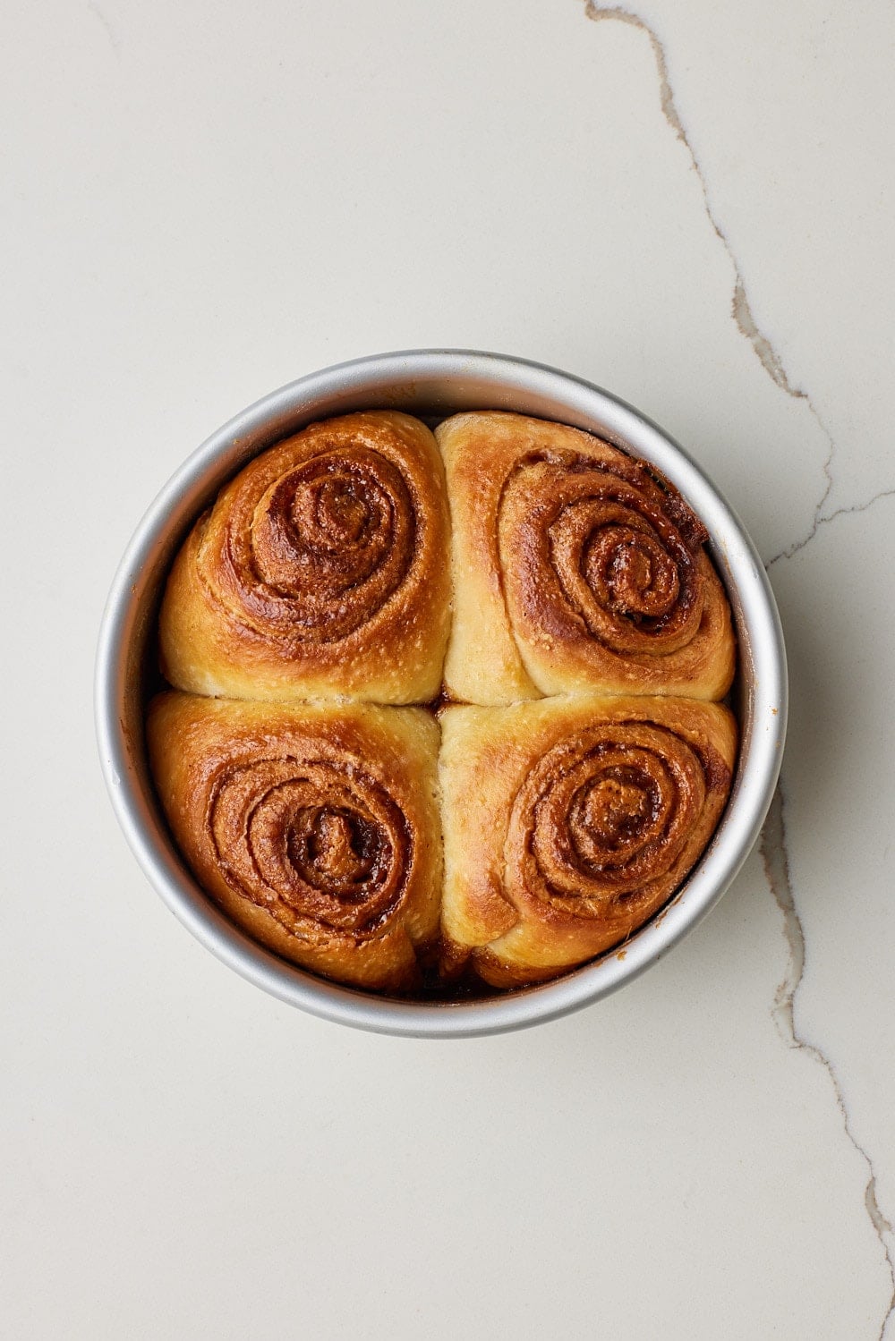 Small Batch Cinnamon Rolls13 Small Batch Cinnamon Rolls baked golden brown in the cake tin.